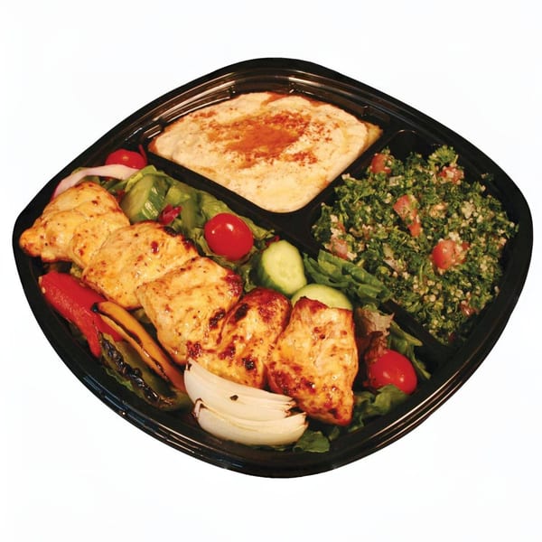 Mediterranean chicken plate with hummus, tabbouleh, grilled vegetables, and salad in a black tray.